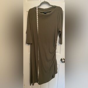 Ribbed knit 3/4 sleeves with a boat neck and asymmetrical hemline